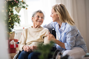 senior woman in wheelchair with caregiver