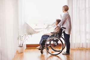 hospice patient in wheelchair at window