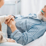 girl talking with grandfather in hospice