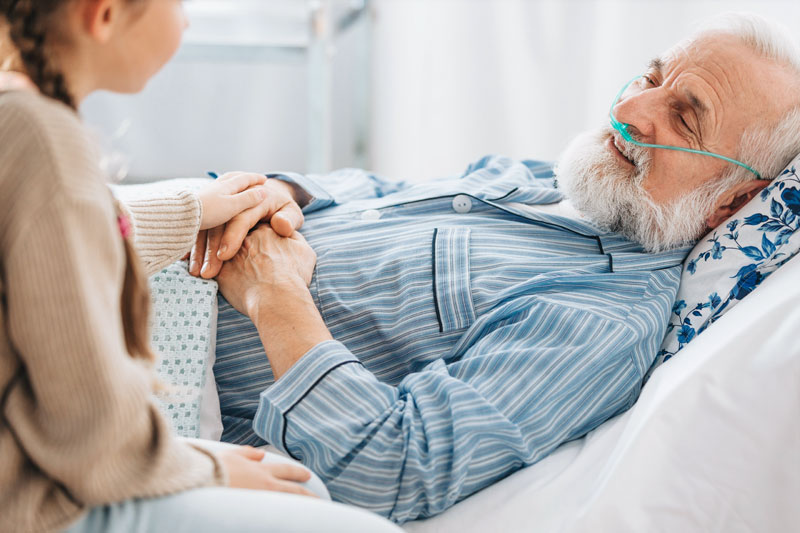 girl talking with grandfather in hospice