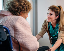 home health aide talking to patient