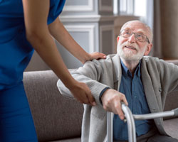 CNA helping patient