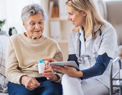 nurse explaining medication to hospice patient