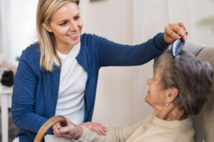 volunteer combing hair of hospice patient